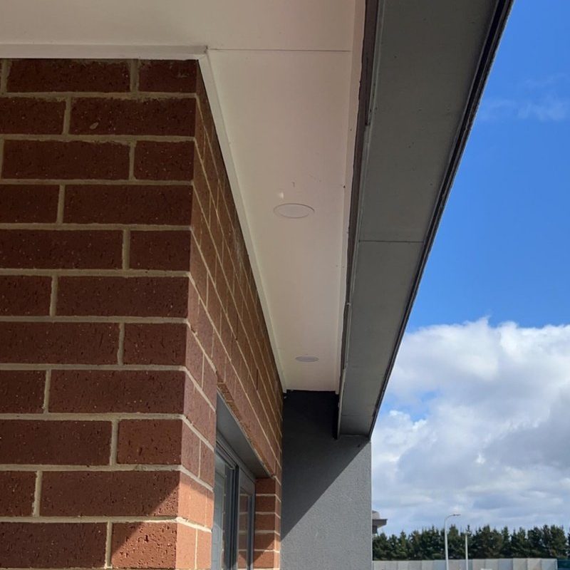 Small downlight in the eave of a red brick house