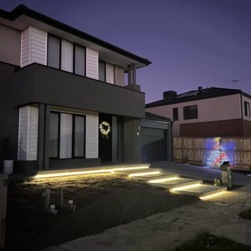 Two-storey house at dusk with LED strip lights under the front steps